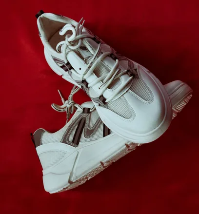 White sneakers on a red backdrop